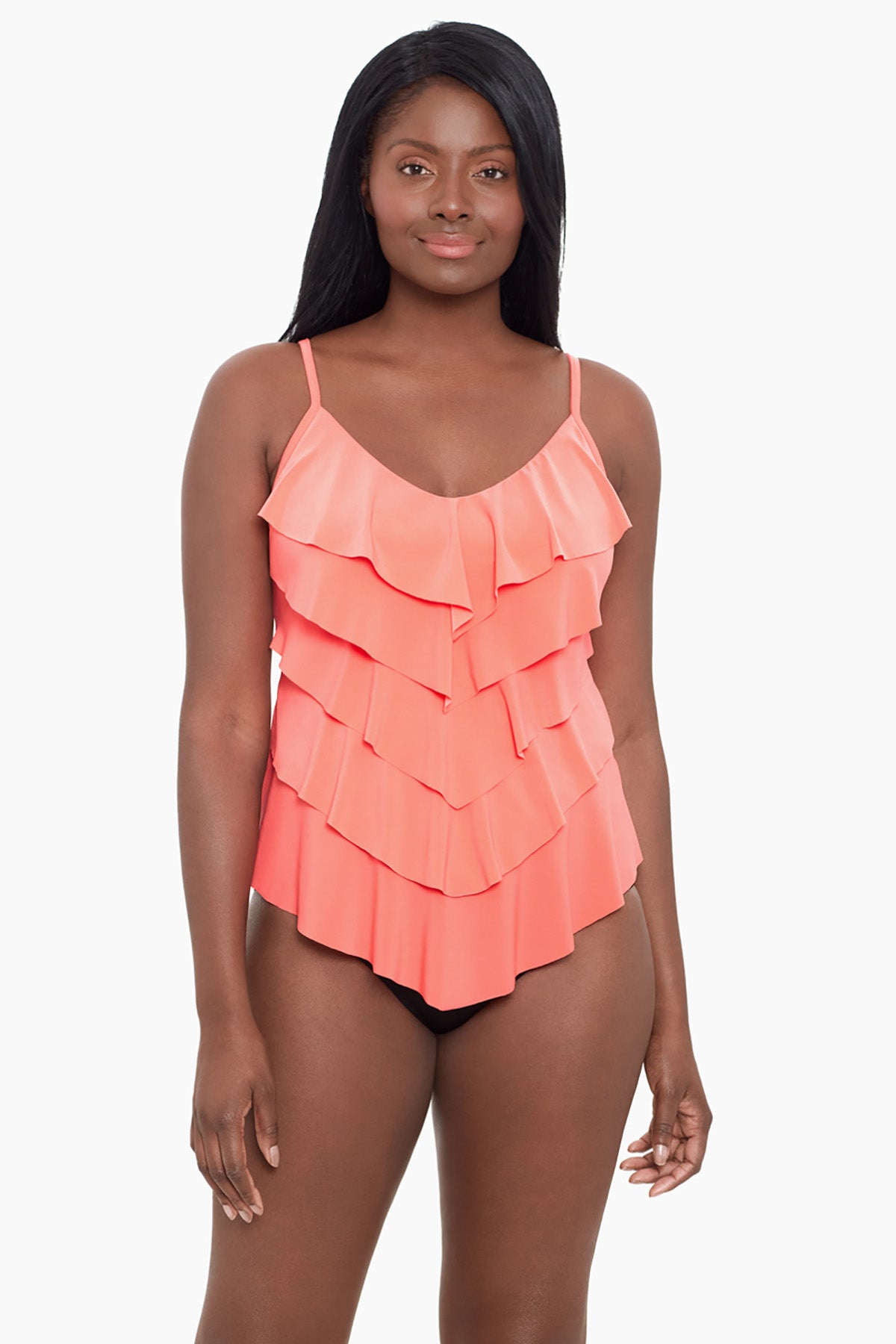 Woman wearing a coral-colored ruffle tankini top
