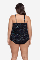 Woman faced away wearing a black and blue polka dotted tankini top