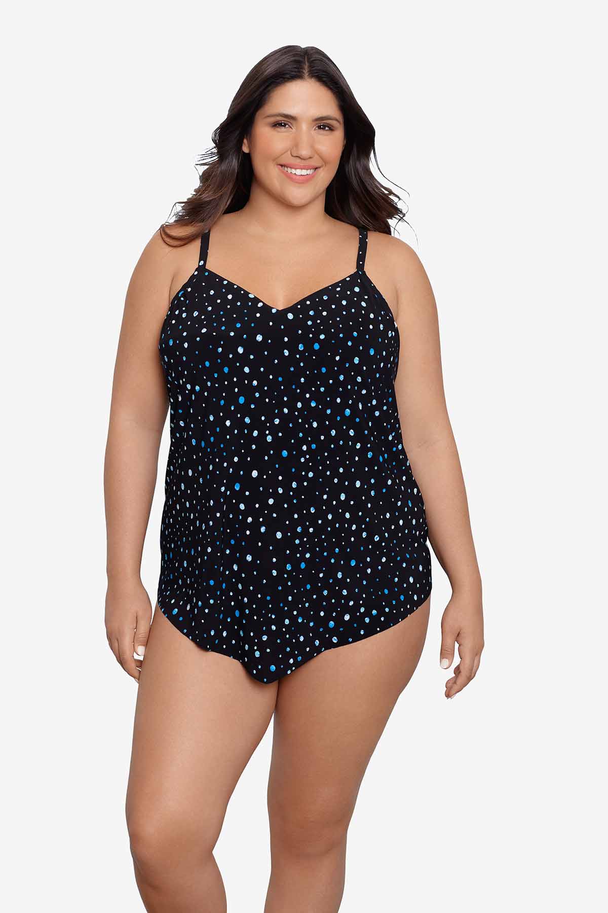 Woman wearing a black and blue polka dotted tankini top