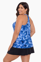 Woman turned left wearing a blue tie dye tankini top