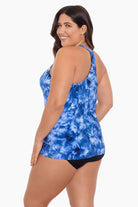 Woman turned left wearing a blue tie dye tankini top
