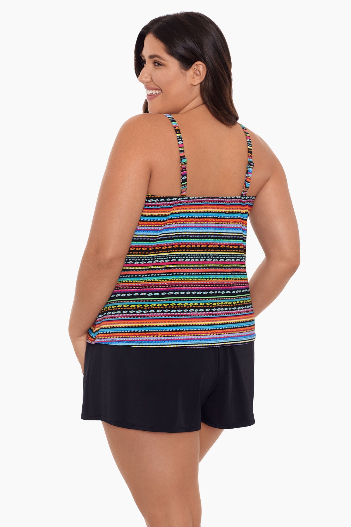 Woman turned left wearing a rainbow stripe and dash pattern swim romper