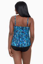 Woman faced away wearing a blue diamond printed tankini top