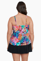 Woman turned away wearing a multicolored palm leaf pattern ruffled tankini top