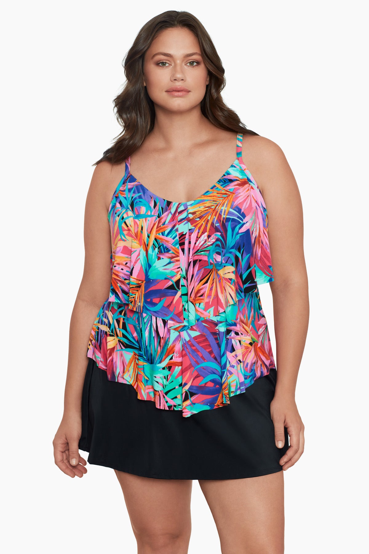 Woman wearing a multicolored palm leaf pattern ruffled tankini top