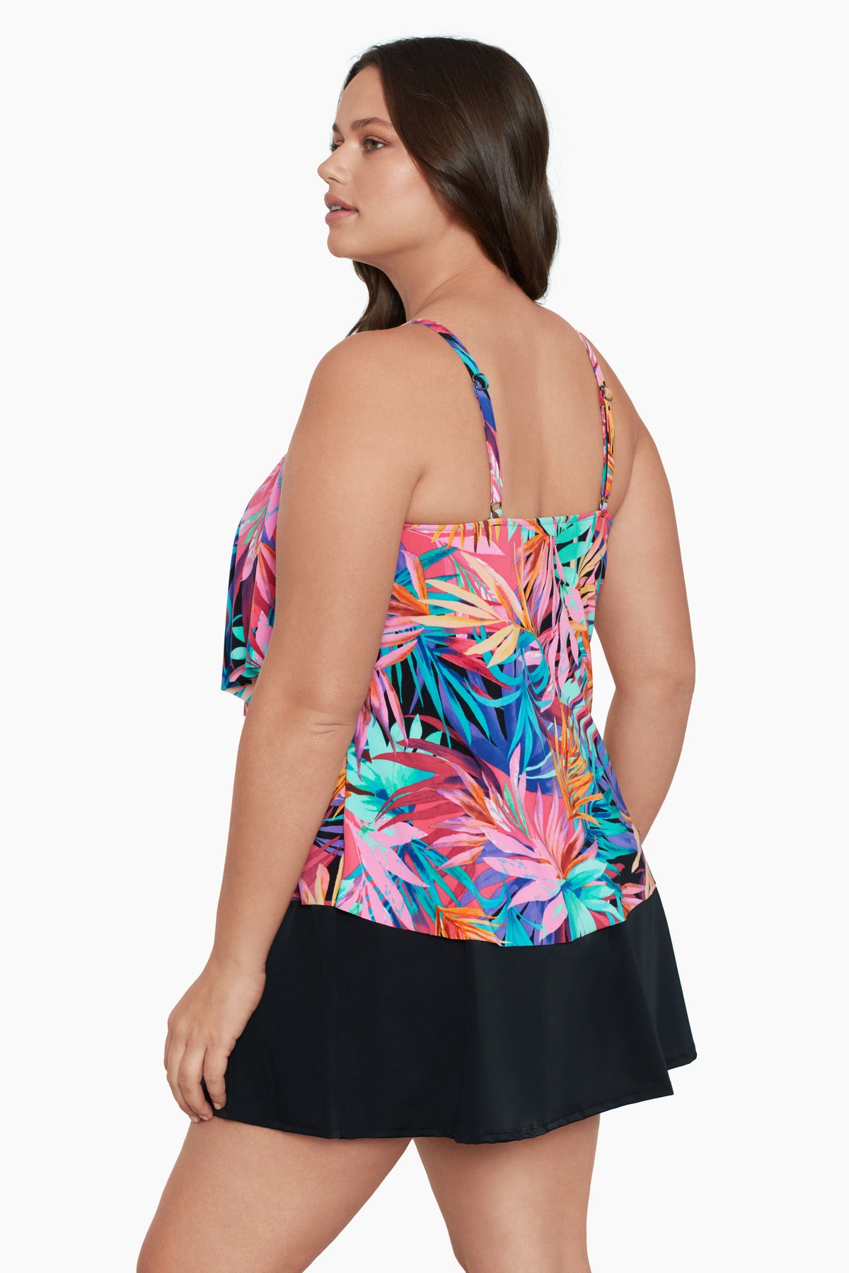 Woman turned left wearing a multicolored palm leaf pattern ruffled tankini top