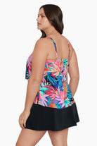 Woman turned left wearing a multicolored palm leaf pattern ruffled tankini top