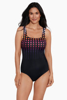 Woman wearing a multicolored faded dotted pattern one-piece swimsuit