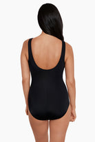 Woman turned away wearing a one-piece swimsuit