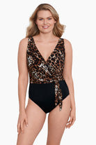 Woman wearing a cheetah print belted surplice one-piece swimsuit