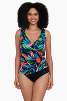 Woman wearing a rainbow paint brush pattern one-piece swimsuit