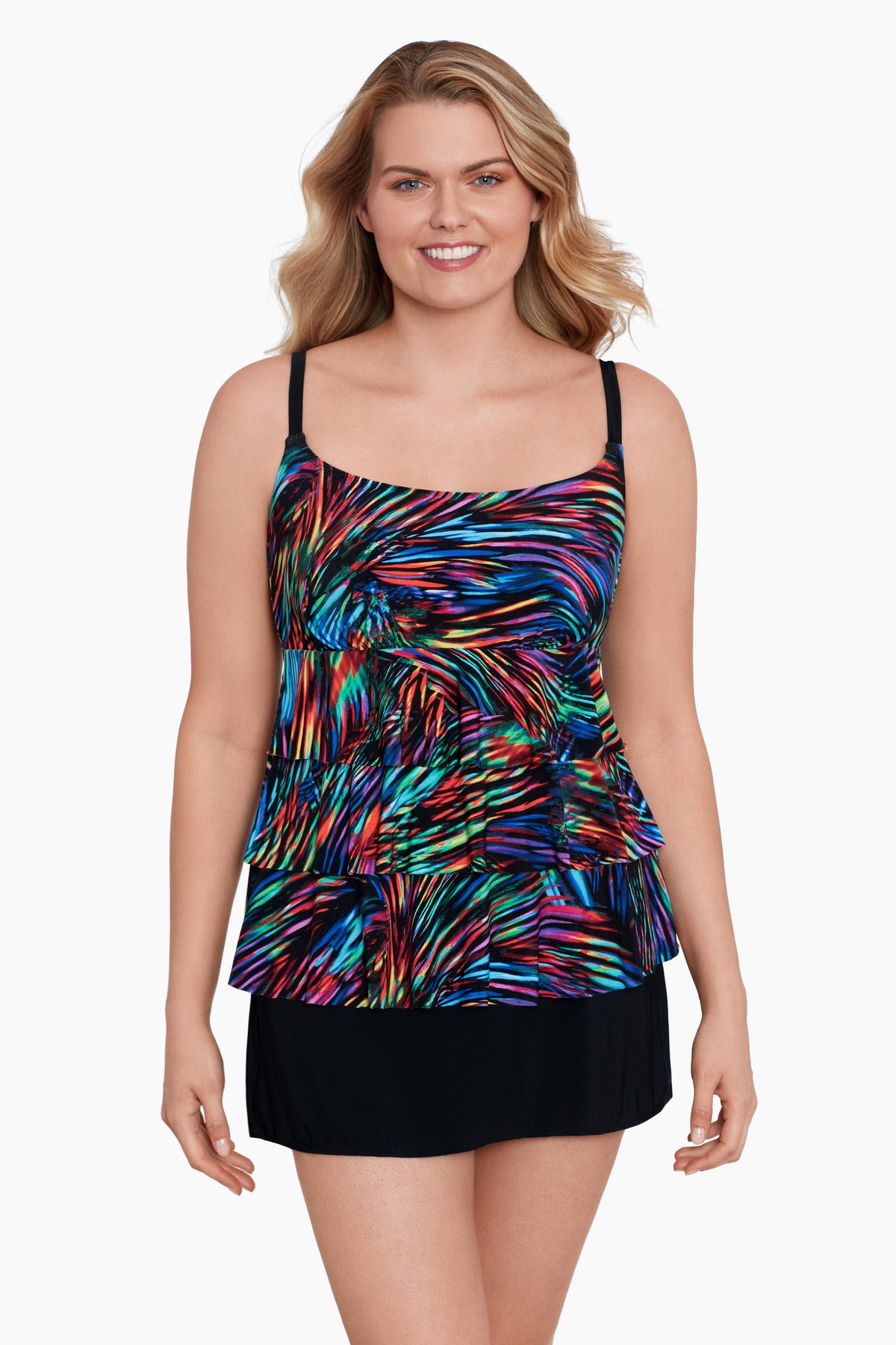 Woman wearing a rainbow light burst pattern ruffle one-piece skirtini swimsuit