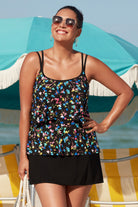 Woman on beach wearing a multicolored tiny floral printed one-piece faux skirtini ruffle swimsuit