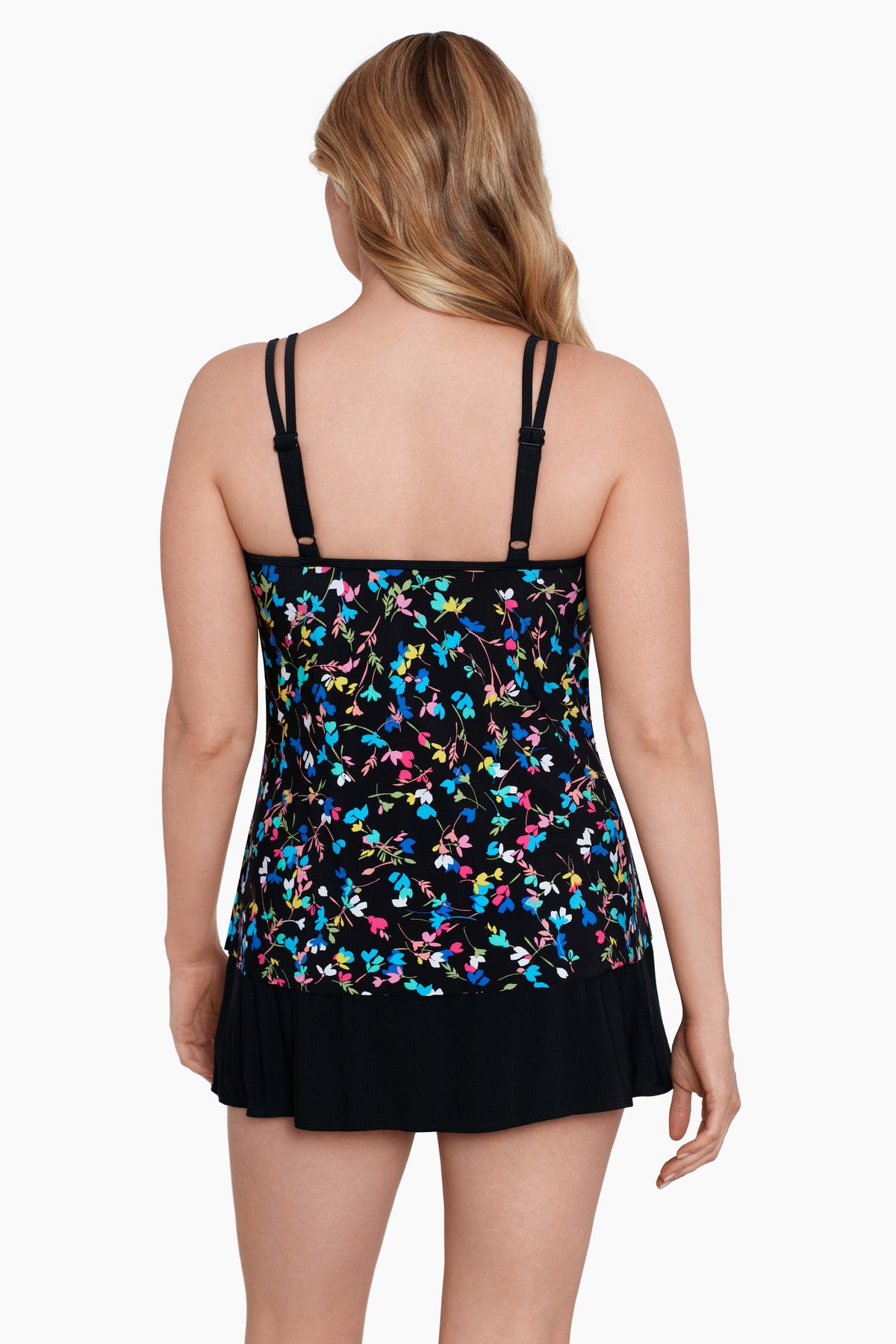 Woman faced away wearing a multicolored tiny floral printed one-piece faux skirtini ruffle swimsuit