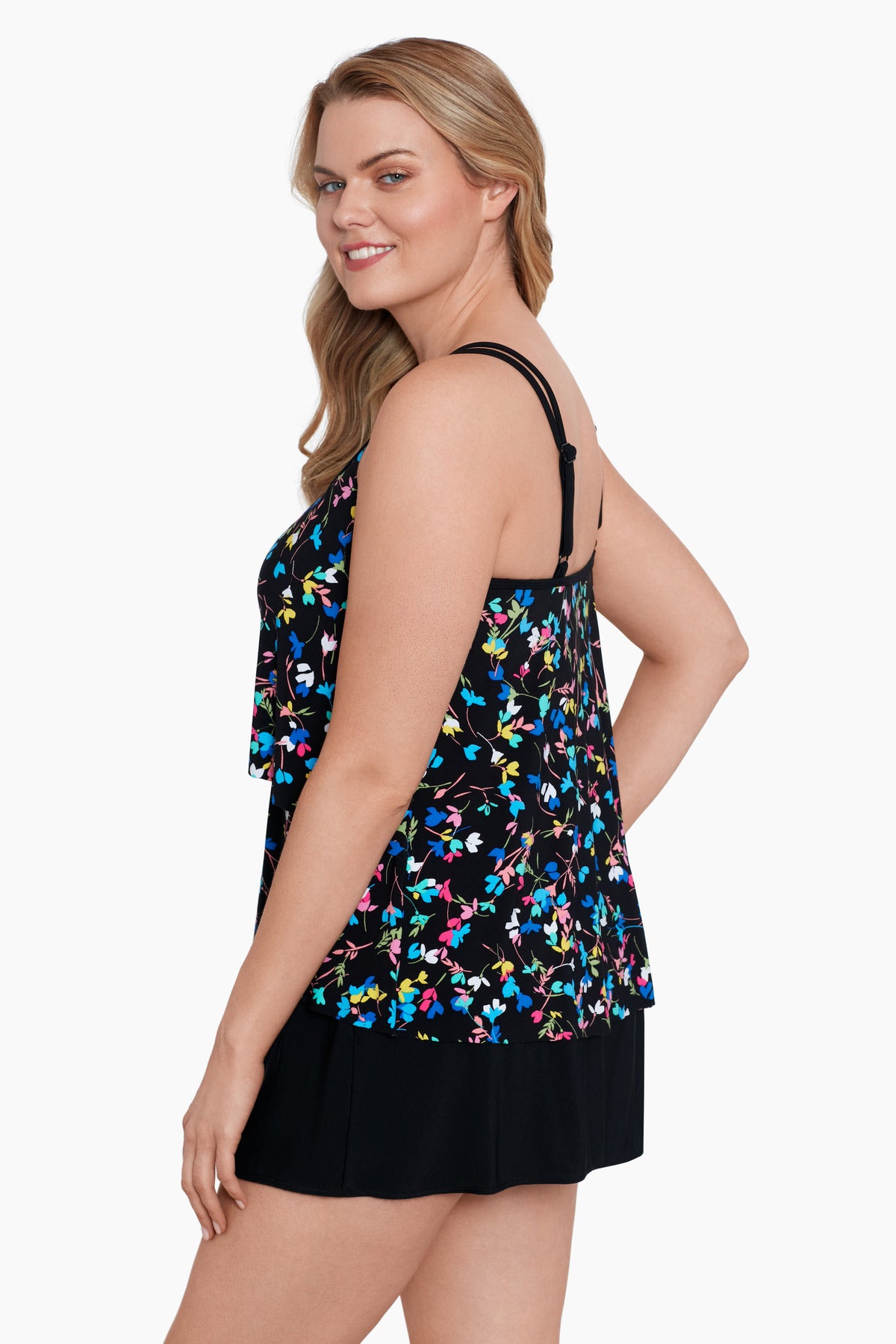 Woman turned left wearing a multicolored tiny floral printed one-piece faux skirtini ruffle swimsuit