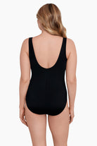 Woman faced away wearing a one-piece swimsuit