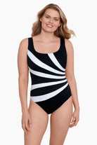 Woman wearing a white and black fan printed one-piece swimsuit