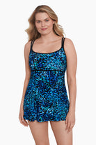 Woman wearing a black and blue petal pattern swim dress