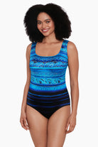 Woman wearing a black and blue ombre abstract print overlay one-piece swimsuit