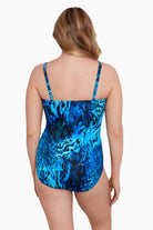 Woman turned away wearing a black and blue abstract animal printed one-piece bandeau swimsuit with straps