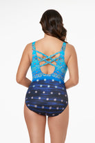 Woman faced away wearing a blue ombre paisley and flower overlay printed one-piece swimsuit